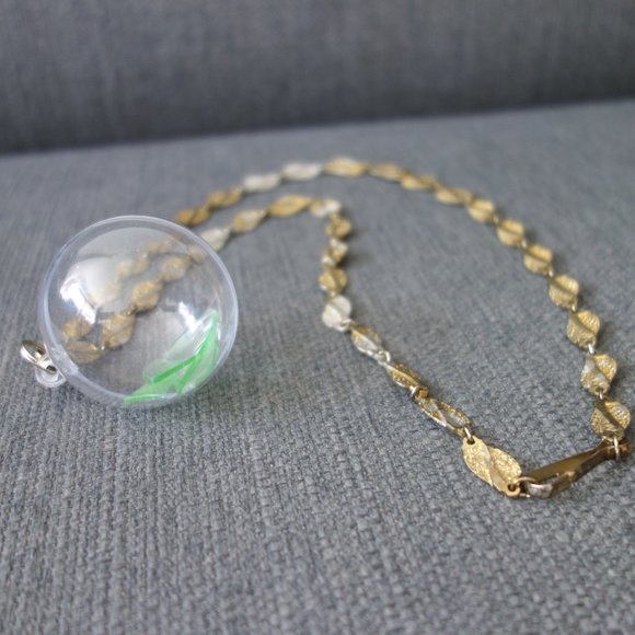 Broken Uranium Glass Inside Plastic Ornament with Metal Necklace - Picture 3 of 10